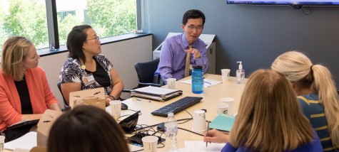 Seattle Cancer Care Alliance Cancer care providers gathered around table discussing patient care