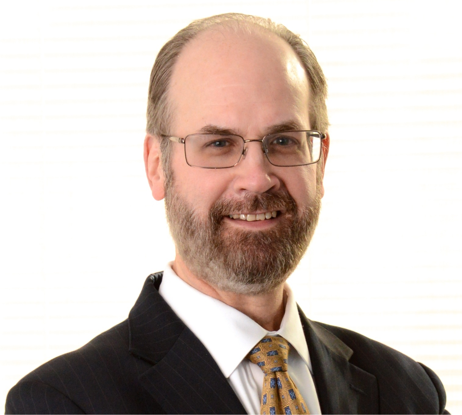 Photo of Charles Engel, a light skinned balding man with glasses and a beard.